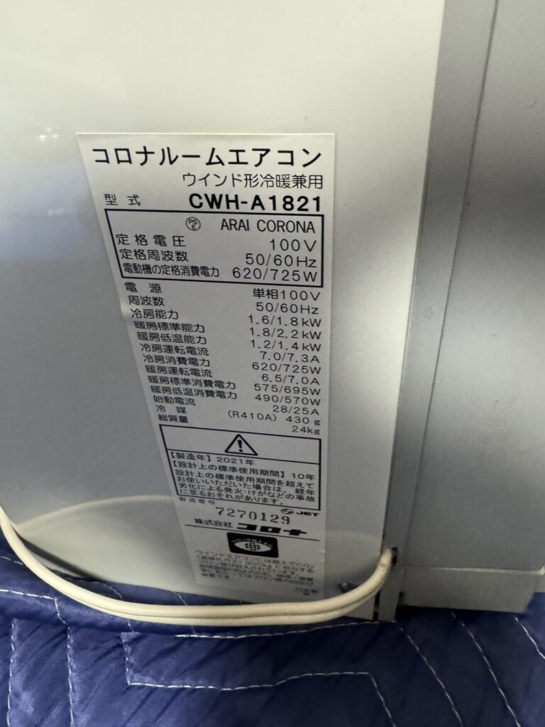 草加市でエアコンクリーニングした窓用エアコンの型番が記載されたシール
